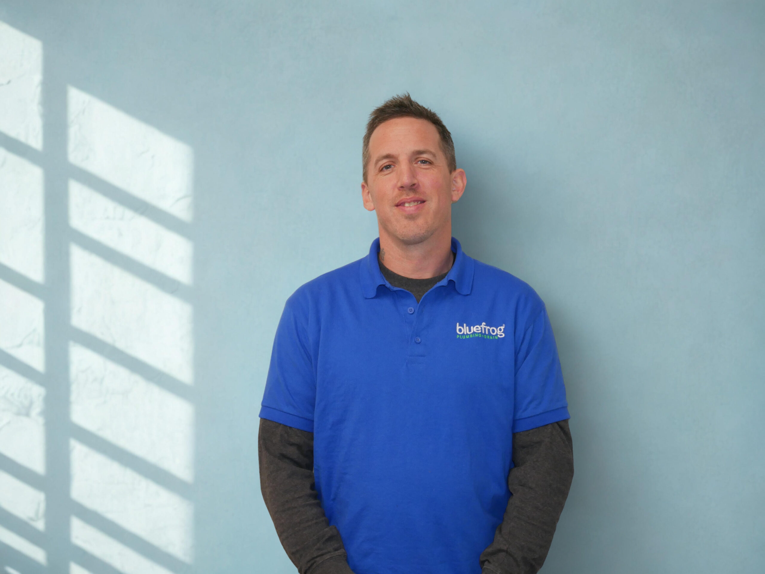 Plumbing technician in blue polo
